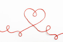 Red Woolen Thread In The Shape Of Heart On White Background