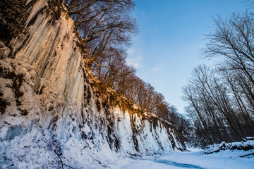 Sunrise at frozen river during winter blue and orange colors