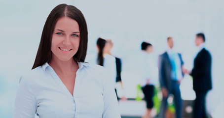 Sticker - Successful business woman standing with her staff in background 