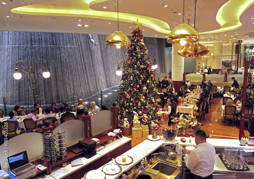 People Have Dinner Near A Christmas Tree At A Restaurant In Dubai