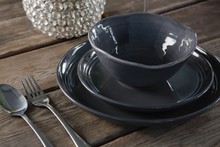 Crockery And Cutlery On Wooden Plank