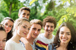 © jackfrog - Group of  young people in a park, they are looking at camera