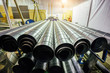 Cylindrical steel pipes. Round metal tubes in metalworking workshop