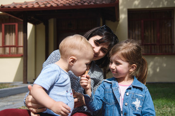 Poster - Boy with Mother and Sister Eating Ice Cream at Yard