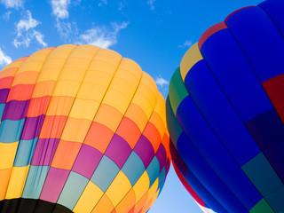 Two colorful hot air balloons on the ground ready to take off - at Winthrop Balloon Festival, Washington state