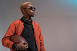 © LIGHTFIELD STUDIOS - Stylish young african american man holding rugby ball isolated on light background