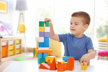 Canvas Print - Cute little boy playing with blocks at home