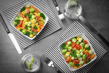 Canvas Print - Plates of tasty salad with Brussels sprouts on table