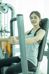 Wall Mural - Attractive Asian woman doing exercise at gym. Woman exercise concept.