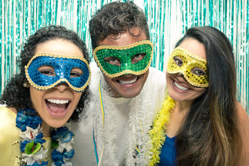 Group of Brazilian friends wearing Carnaval costume. Revelers are posing for the picture..