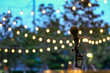 © Uraiwon - Microphone stand for the singer with the light hanging in the park background