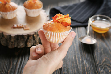 Poster - Woman holding tasty bacon muffin, closeup