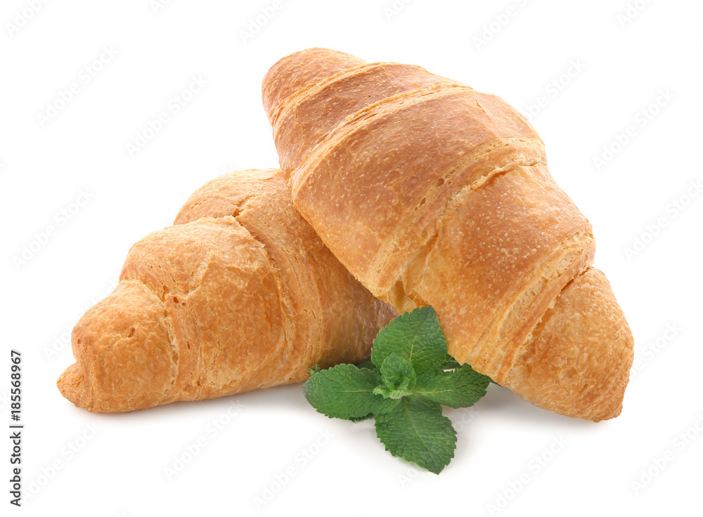 Yummy fresh croissants with mint on white background