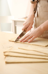 Poster - Woman cutting puff pastry on table