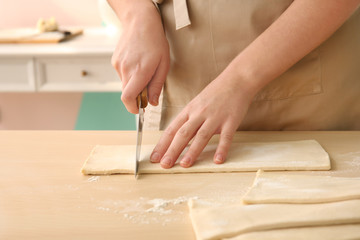 Poster - Woman cutting puff pastry on table