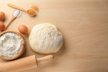 Wall Mural - Fresh raw dough with ingredients on wooden table