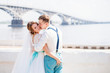 © johnalexandr - the bride and groom are photographed on the background of the bridge
