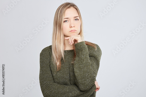 Cuadros en Lienzo Studio shot of beautiful European female woman with grumpy expression being offended after quarrel with parents or boyfriend