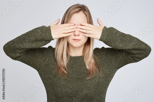 Desperate Female With Blonde Long Hair Covering Face With Hands