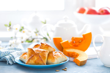 Poster - Delicious homemade baking. Patties with fresh pumpkin on white background, closeup