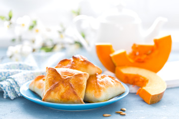 Poster - Delicious homemade baking. Patties with fresh pumpkin on white background, closeup