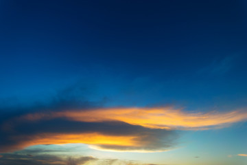 Wall Mural - Sky blue and orange light of the sun through the clouds in the sky