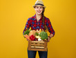 happy young woman grower with box of fresh vegetables
