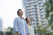 © allensima - portrait of young Chinese couple standing & smiling outdoor in garden