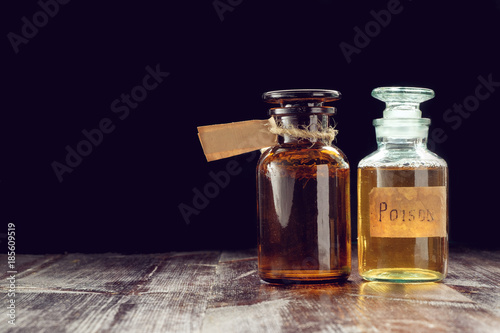 Fotografía pair of apothecary bottles with potion of poison or tincture