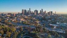 Cinematic Urban Aerial Time Lapse Of Downtown Los Angeles Skyline With Freeway Traffic.