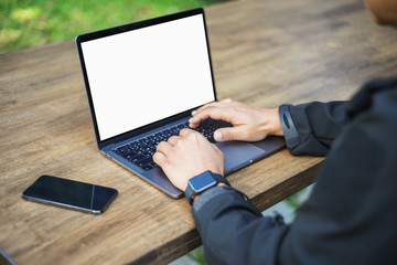 Fototapete - Male person sitting front open laptop computer with blank empty screen for your information or content,modern businessman work in internet via notebook, student at coffee shop learning