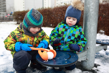 children playing with snowball maker