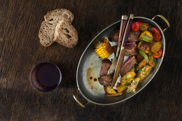 Wall Mural - Beef steak fried potatoes vegetables pan glass of red wine