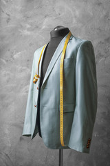 Wall Mural - Custom-made suit on mannequin against grey background