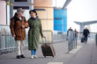© Yakobchuk Olena - Enjoy your life. Full length of encouraged calm retired man and woman are talking to each other while standing outdoors. They are carrying suitcase while looking at each other with love. Copy space