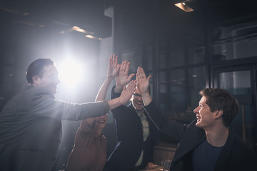 Aufkleber - Outgoing men and cheerful lady putting arms together while standing in apartment. Enthusiasm concept