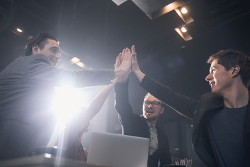 Aufkleber - Low angle happy young startup team slapping hands in modern office. Job concept