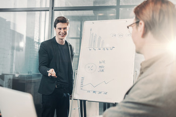 Aufkleber - Portrait of happy male showing statistics to partner while standing opposite him in apartment. Presentation and business concept