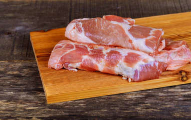 Horizontal photo of pork meat. Big portion of pork meat on chopping board.