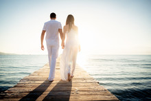 Young Couple Walking On Pier
