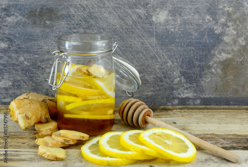 Closeup image of ingredients for natural cold or flu remedy includes ginger, hon Poster