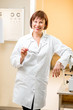 © rh2010 - Portrait of a senior woman doctor in uniform standing in the ophthalmologic office