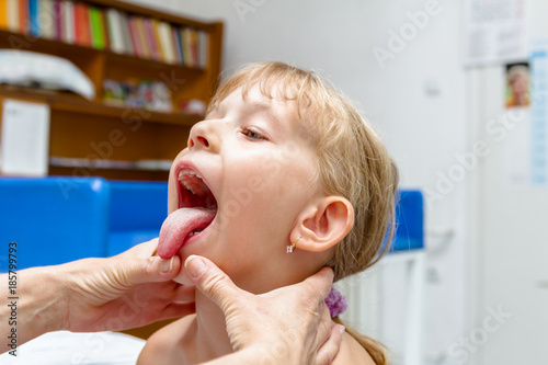 Little Girl Putting Out Her Tongue Having A Physical Exam At The Doctor Stock Photo Adobe Stock