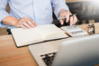 © snowing12 - business men working on wooden desk(table) with notebook computer paper, pencil and hand in office, financial concept.