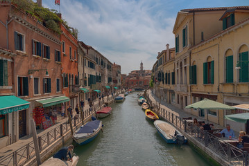 Wall Mural - Traditional narrow canal street with gondolas and old houses in Venice, Italy. Architecture and landmarks of Venice. Beautiful Venice postcard.