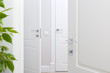 Modern chrome door handle on white door. Beautiful interior closeup