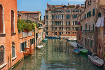 Wall Mural - Traditional narrow canal street with gondolas and old houses in Venice, Italy. Architecture and landmarks of Venice. Beautiful Venice postcard.