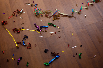 Shot of a wooden floor after a party celebration with party poppers and confetti