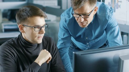 Aufkleber - Experienced Senior Engineer Consults Young Designer about Project, They Have Discussion and Work on a Personal Computer. Shot on RED EPIC-W 8K Helium Cinema Camera.