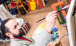 © Stavros - Closeup of painter artist working in a modern abstract oil canvas in his studio